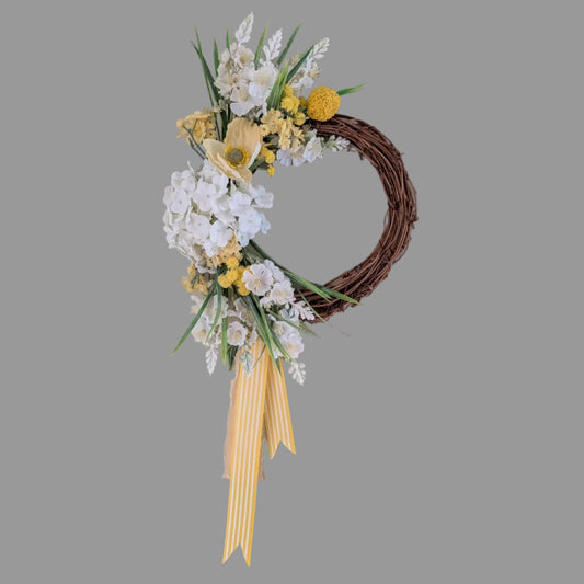 Lemon Meringue Pie wreath - on a 20 cm grapevine base with lemon and white faux flowers and a signature candy striped yellow ribbon and lemon chiffon ribbon