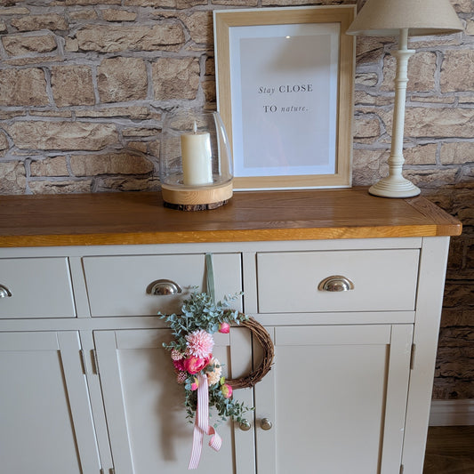 Rhubarb & Custard 20cm wreath shown against a pale grey side unit