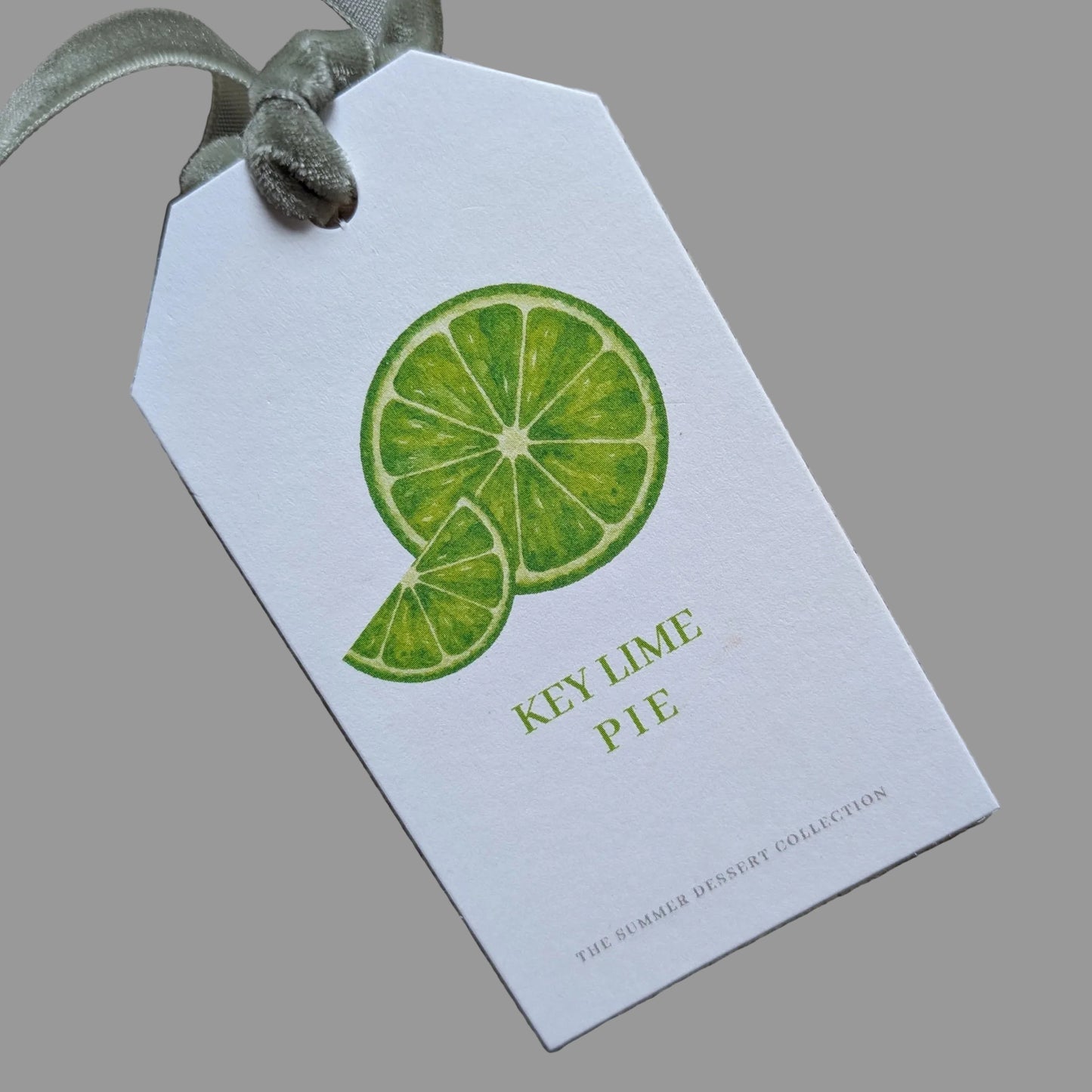 Close up of the front of Key Lime Pie tag with a sage green velvet ribbon