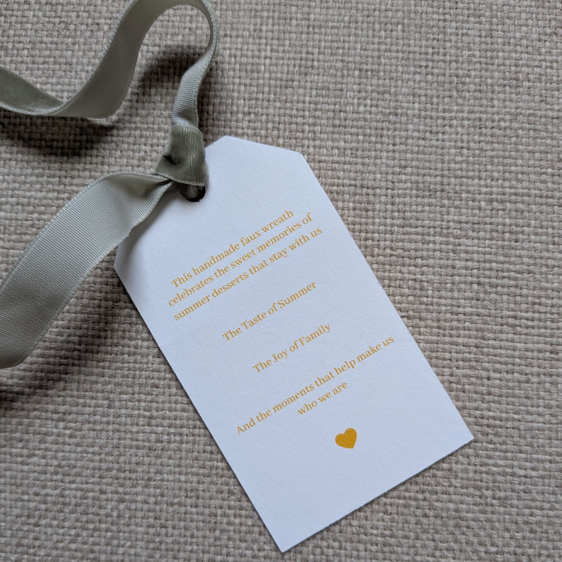 Close up of the back of the Lemon Meringue Pie tag with a sage green velvet ribbon