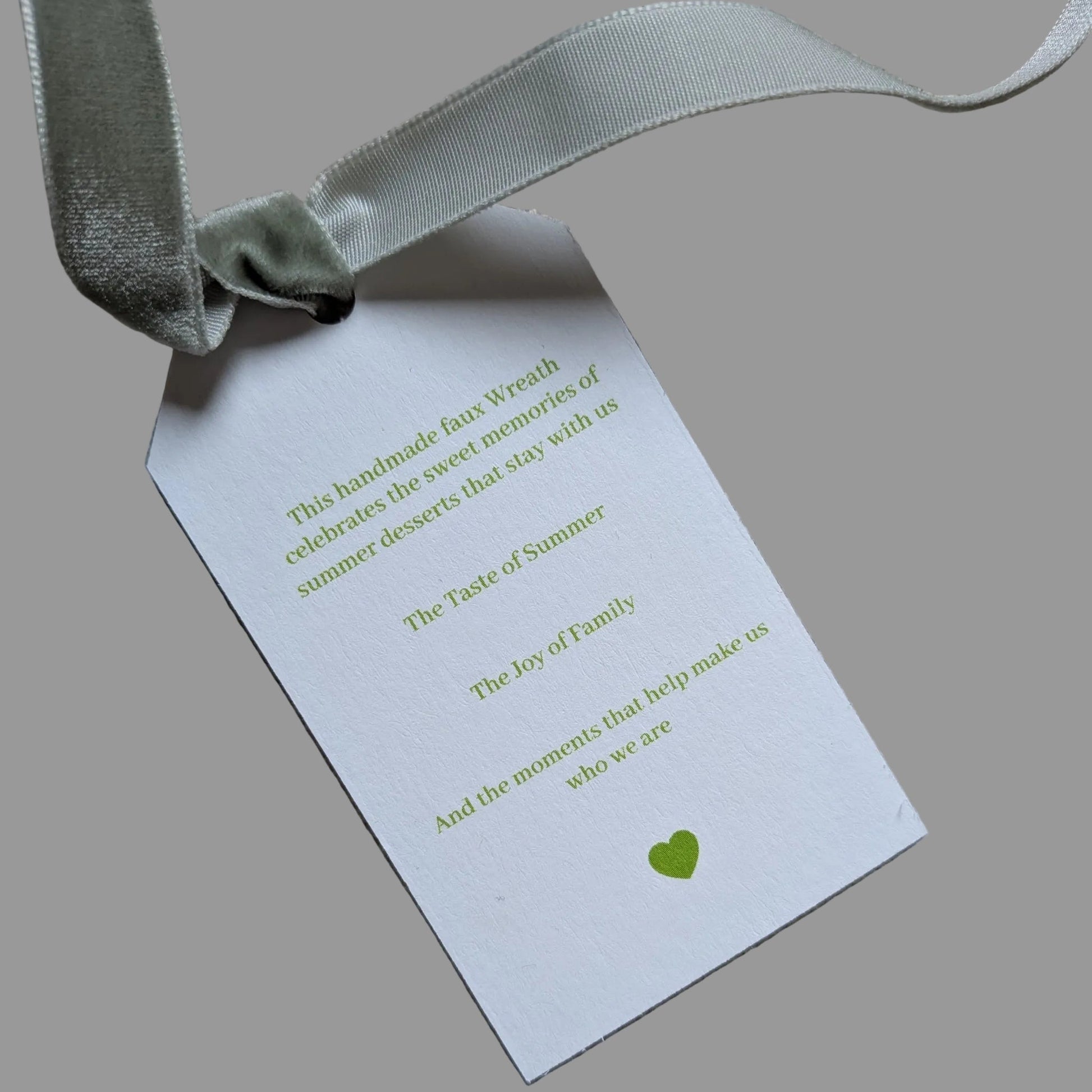 Close up of the back of the Key Lime Pie tag with a sage green velvet ribbon